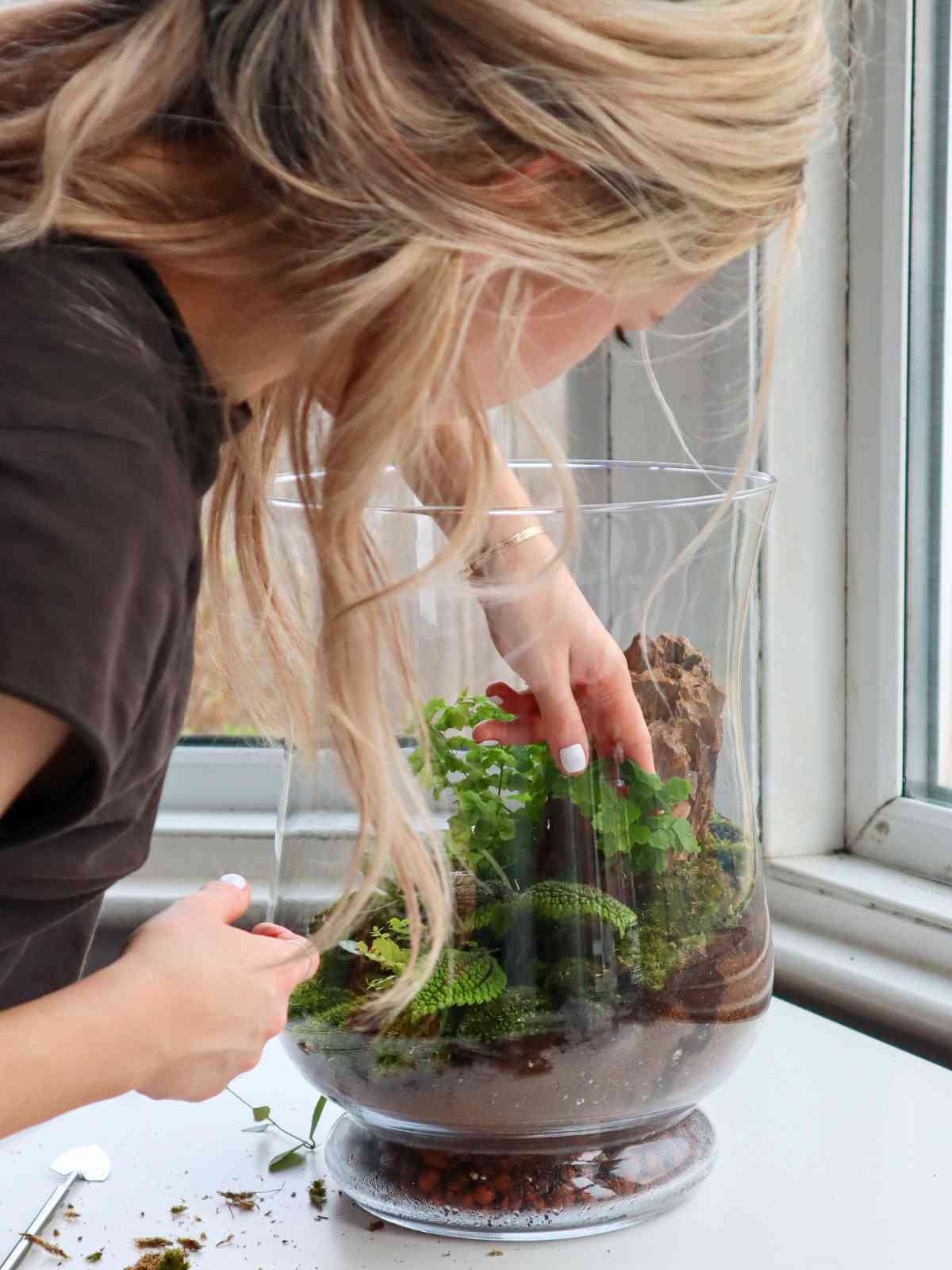 girl planting a terrarium
